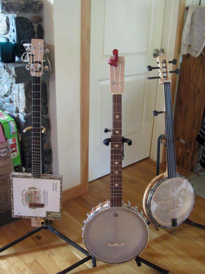 Cigar box and two open-backed banjos